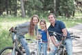 Portrait of a happy family with a little daughter on a bike ride Royalty Free Stock Photo