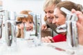 Portrait of a happy family looking for a new bathroom sink faucet Royalty Free Stock Photo