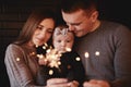 Portrait of happy family, mom, dad and baby girl with sparklers and light. family in anticipation of Christmas. selective photo Royalty Free Stock Photo