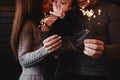 Portrait of happy family, mom, dad and baby girl with sparklers and light. family in anticipation of Christmas. selective photo Royalty Free Stock Photo