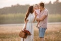 Portrait of happy family. Mom, dad and daughter walk in the field. Young family spending time together on vacation Royalty Free Stock Photo