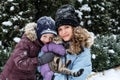 Portrait of happy family mother, son and cat in snowy winter park. Outdoors Portrait of mom and kid boy with cat hugging Royalty Free Stock Photo