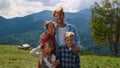 Portrait happy family mountains summer holiday. Couple hugging with children. Royalty Free Stock Photo