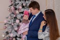 Portrait of happy family near Christmas tree.Family, christmas, winter,happiness and people concept