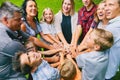 Happy family with nine children heaping hands