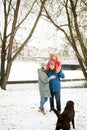 Portrait of happy family with one kid and dog in winter casual outfit Royalty Free Stock Photo