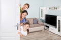 Portrait Of Happy Family Peeking From Door