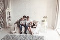 Portrait of a happy family and a pet sitting on a sofa Royalty Free Stock Photo