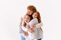 Portrait of happy family, redhaired parents and kid in casual wear look at camera with smile, have good family