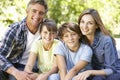 Portrait Of Happy Family Sitting In Garden Together Royalty Free Stock Photo