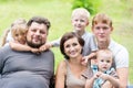 Portrait of happy family sitting on the grass Royalty Free Stock Photo