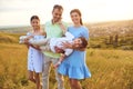 Portrait of a happy family sitting on nature in the grass. Royalty Free Stock Photo