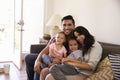 Portrait Of Happy Family Sitting On Sofa In at Home Royalty Free Stock Photo