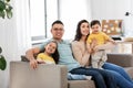 Portrait of happy family sitting on sofa at home Royalty Free Stock Photo