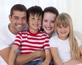 Portrait of happy family sitting on sofa together Royalty Free Stock Photo