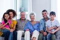 Portrait of happy family sitting together on sofa Royalty Free Stock Photo