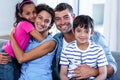 Portrait of happy family sitting together on sofa Royalty Free Stock Photo