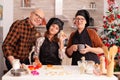 Portrait of happy family smiling while holding cookies homemade dough