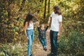 Portrait of happy family standing on path in autumn forest Royalty Free Stock Photo