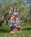 Portrait of a happy family on a swing in their garden Royalty Free Stock Photo