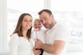 Portrait of happy family of three. Parents with their beautiful baby girl at home. Royalty Free Stock Photo