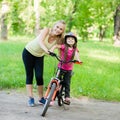 Portrait of a happy family, to ride a bike in the park Royalty Free Stock Photo
