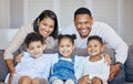 Portrait, happy family and together with smile on couch for relaxing, peace and break in home. Parents, kids or siblings