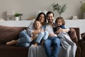Portrait of happy family with two kids sitting on couch Royalty Free Stock Photo