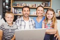 Portrait of happy family using laptop at home Royalty Free Stock Photo