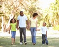 Portrait of Happy Family Walking In Park Royalty Free Stock Photo
