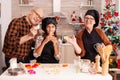 Portrait of happy family wearing apron holding cookies homemade dough