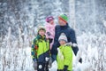 Portrait of a happy family in winter park. Father, son and little daughter laughing Royalty Free Stock Photo