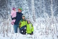 Portrait of a happy family in winter park. Father, son and little daughter laughing Royalty Free Stock Photo
