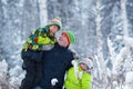 Portrait of a happy family in winter park. Father, son and little daughter laughing Royalty Free Stock Photo