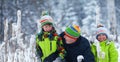 Portrait of a happy family in winter park. Father, son and little daughter laughing Royalty Free Stock Photo