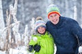 Portrait of a happy family in winter park. Father, son and little daughter laughing Royalty Free Stock Photo