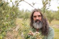 Portrait of happy farmer observing examining olive