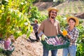 Portrait of happy farmers with mango harvest in orchard