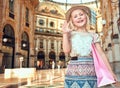 Portrait of happy fashion girl with shopping bag hand waving