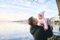 portrait of happy father with adorable baby girl enjoying nice view of winter lake Geneva or Lac Leman, Montreux, Switzerland Royalty Free Stock Photo