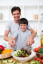 Portrait of a happy father cooking with his son