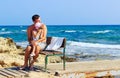 Portrait of happy father embracing cute little daughter on background of sea