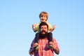 Portrait of happy father giving son piggyback ride on his shoulders. Cute boy with dad playing outdoor. Kid son hugging Royalty Free Stock Photo