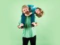 Portrait of happy father giving son piggyback ride on his shoulders. Generations family. Royalty Free Stock Photo