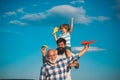 Portrait of happy father giving son piggyback ride on his shoulders and looking up. Dream of flying. Fathers day concept Royalty Free Stock Photo