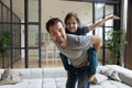 Portrait happy father piggybacking little son, having fun at home Royalty Free Stock Photo