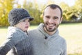 Portrait of happy father son in autumn park Royalty Free Stock Photo