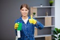 Portrait of happy female cleaner with cleaning equipment in office Royalty Free Stock Photo