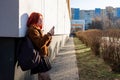 A portrait of a happy female college student using smartphone at campus. Royalty Free Stock Photo