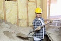 Portrait of a happy female contractor digging sand at construction site Royalty Free Stock Photo